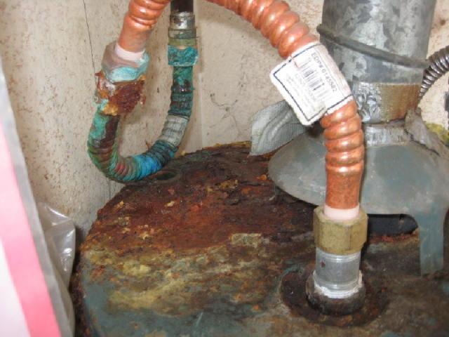 Corroded, leaking water line at top of water heater